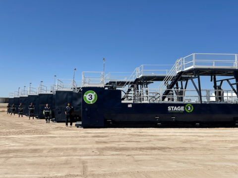 original Stage 3 Separation field technicians next to equipment. (Photo: Business Wire)