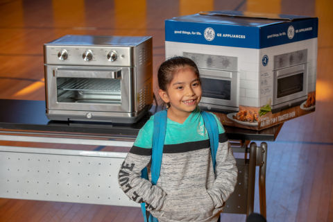 Student standing in front of toaster oven (Photo: GE Appliances, a Haier company)