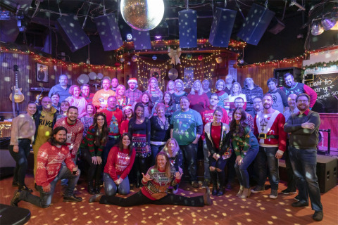 Staffers from DirectEmployers Family of Brands strike a pose at the organization's 2019 Holiday Party, which featured an afternoon of karaoke, dancing, and connection at Howl at the Moon in downtown Indianapolis, Indiana. (Photo: Business Wire)