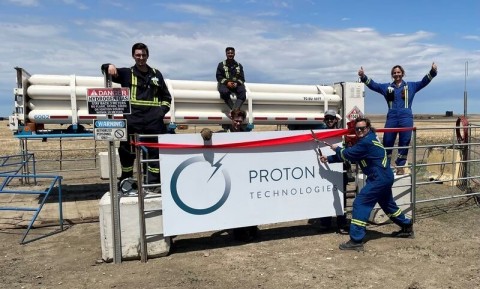 Proton Technologies Canada team members pose in front of a new tube trailer (Photo: Business Wire)