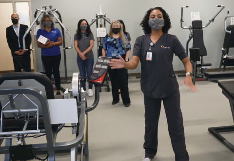 Stephanie Wallace, MS, CEP, Optum gives a tour of the new gym open to the public during the grand opening event for Optum-Hemet Clinic and Community Center. Credit: Sandy Huffaker