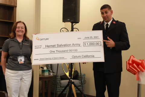 (L-R) Jamie Phillips, Optum, presents $1,000 check to Lieutenant James Fleming, Hemet Corps Officer Salvation Army to support summer programs in the community.  The check presentation was part of the grand opening. Credit: Sandy Huffaker