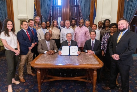 Governor Abbott signs the Bonton Farms Act into law surrounded by Bonton Farms staff and supporters. (Photo: Office of the Texas Governor)