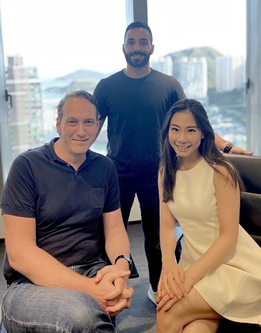 Anastasios Papadopoulos (standing), Dennis Plomp and Emmy Chung of IMS Digital Ventures (Photo: Business Wire)