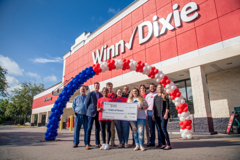 Southeastern Grocers associates present a $1.5 million donation to Folds of Honor and scholarship recipients on behalf of valued partners, generous in-store customer donations and the grocer’s charitable foundation. (Photo: Business Wire)