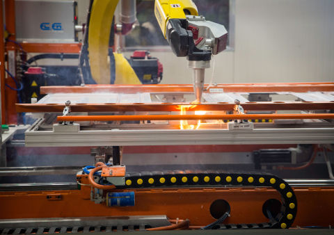 Laser pierce robots cutting holes (Photo: GE Appliances, a Haier company)