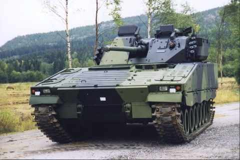original A combat-proven CV9030FIN on a gravel road in front of a green forest. Finland is the latest in a series of CV90 customers to reinvest in the infantry fighting vehicle platform. (Photo: BAE Systems)