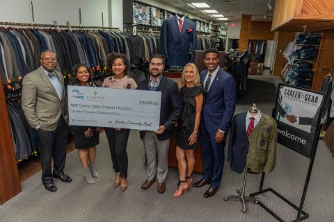 Veritex Community Bank’s Courtney Taylor (second from left), Career Gear Greater Houston representatives and Houston City Councilman Edward Pollard (far right), celebrate a $16,000 funding award during a ceremonial check presentation at Career Gear’s Houston facility. (Photo: Business Wire)