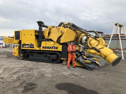 Andy Charsley, a principal mining engineer at Vale, stands by the new Komatsu MC51 machine featuring DynaCut mechanical cutting technology. Komatsu and Vale are working together to increase the pace at which the innovative technology will be available to the larger market. (Photo: Business Wire)