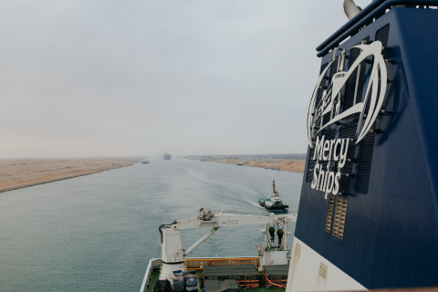 The Global Mercy (R) sailed through the Suez Canal on the way to a courtesy stop in Malta. (Photo: Business Wire)