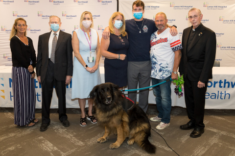 Patients from Northwell Health’s World Trade Center Health Program gather to reflect on 9/11 20 years later. From left: Christina Huie, Fred Eichler, Dr. Jacqueline Moline, Denise Lynch and son Michael, Scott Bartells and Father Paul Wierichs with service dog, Adolf. Credit Northwell Health.