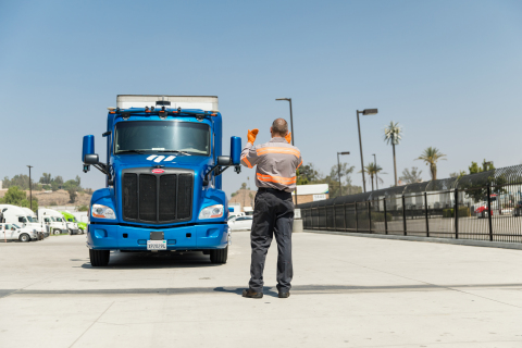 A Ryder technician guides an Embark autonomous truck with a safety driver behind the wheel in Riverside, Calif. Ryder will provide yard operations, maintenance, and fleet management to support a seamless coast-to-coast autonomous network for Embark fleet partners. (Photo: Business Wire)