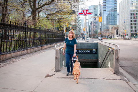 Denise Chamberlin with her guide dog Ridley emerges from the Toronto subway. (Photo: Business Wire)