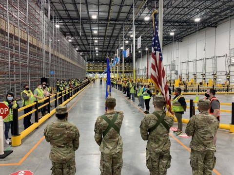 The North Dakota State University Color Guard leads associates through the Fargo Amazon Fulfillment Center's opening ceremony (Photo: Business Wire)