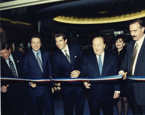 Ribbon Cutting At Hudson News in 1998 As Part Of The Rededication of the Revitalized Grand Central Terminal, 20 Years After Former First Lady Jacqueline Kennedy Onassis Saved The Terminal. Pictured left to right: Mario DiDomizio, James S. Cohen, John F. Kennedy Jr., Robert B. Cohen, Hope Remoundos and Roger Fordyce. (Photo: Business Wire)