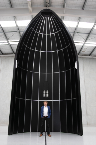 Rocket Lab CEO Peter Beck stands with a Neutron fairing half. (Photo: Business Wire)