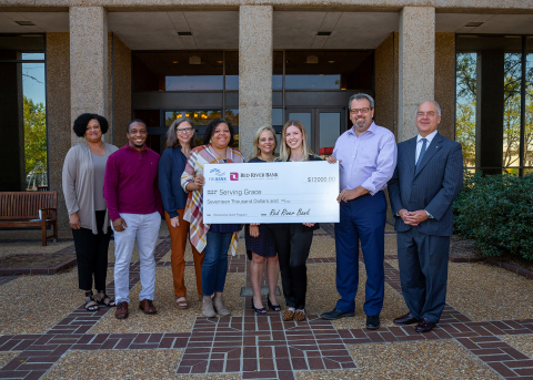 Officials from Red River Bank and Serving Grace pose with a ceremonial check to celebrate a <money>$17,000</money> Partnership Grant Program award from the Federal Home Loan Bank of Dallas and Red River Bank. (Photo: Business Wire)