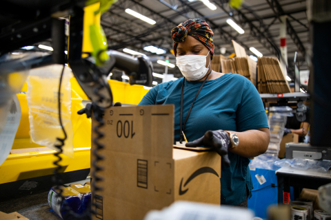 Team member packing an order in an Amazon facility (Photo: Business Wire)