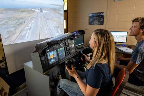 Two South Dakota Mines students use the university flight simulator in the Department of Electrical Engineering. Raven Industries' gift will enhance the Mines’ new minor in avionics. (Photo: Business Wire)