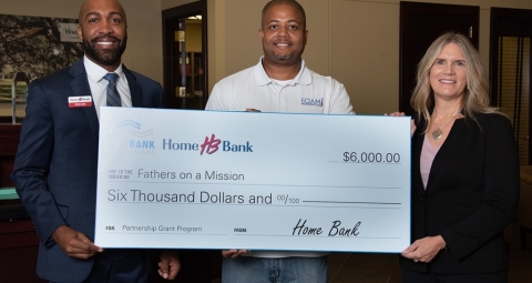 From Left: Kelvin Luster with Home Bank, Levar Robinson with Fathers on a Mission and Elizabeth Jewell with the Federal Home Loan Bank of Dallas. (Photo: Business Wire)