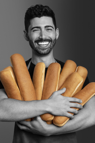 Hero Bread Founder and Chief Executive Officer Cole Glass is pictured holding Hero Bread footlong sandwich rolls exclusively available at select Subway® locations. (Photo: Business Wire)