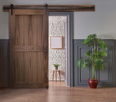 Our Craftsman style double panel Walnut sliding barn door embodies timeless Cambridge style with the security of a UL752 level 3 bullet resistant core. Simple and balanced, this solid wood door will fit right into your home, school, or office. Handsome wood grain and naturally occurring elements give any space an organic touch. (Photo: Business Wire)