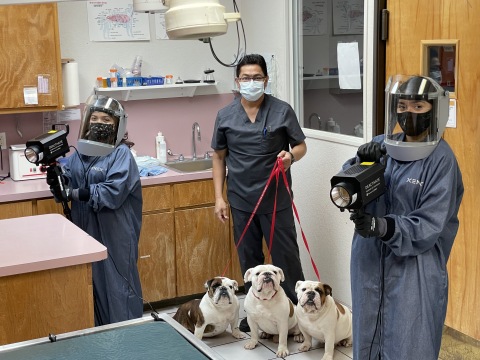 Carrollton West Pet Hospital is the first animal hospital to use Xenex Deactivate germ-zapping devices to disinfect rooms throughout the facility. Two employees pose for a photo as they prepare to start disinfecting rooms as another employee walks by with 3 very cute customers. (Photo: Business Wire)