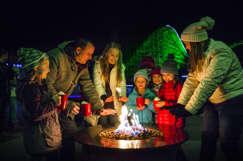 Enjoy thrilling coasters, millions of dazzling lights, and cozy up to warm firepits at Six Flags Holiday in the Park. (Photo: Business Wire)