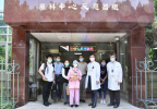 A Japanese woman (center, holding teddy bear with a graduation cap) in front of the NSTDC with the medical team after receiving BNCT for a malignant brain tumor. (Photo: National Tsing Hua University)
