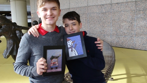 Landon and Chase Graham with their holiday card artwork. (Photo: Business Wire)