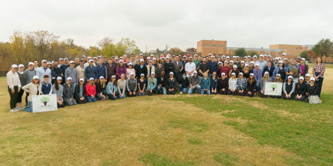 Crow Holdings employee volunteers participate in the company’s annual local tree planting event in Dallas. (Photo: Business Wire)