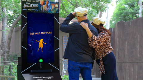 Visitors at Disneyland pose in front of the “Jungle Cruise” interactive movie poster created by Accenture and StudioLAB. (Photo: Business Wire)