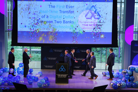 Top banks from across the nation celebrate the first ever real-time transfer of digital dollars using blockchain technology during a live demonstration of the Digital Interbank Network (“The Network”) hosted by Tassat Group Inc. on Thursday, Dec. 16 2021, in New York. “The Network,” owned and governed by member banks, will enable banks of all sizes to compete in the $25 trillion B2B payments market. (Jason DeCrow/AP Images for Tassat Group, Inc.)