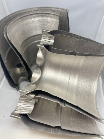 original A combustor liner made using Amperprint® 0233 Haynes® 282® powder from Höganäs. The part features 23,000 unique holes for optimized air-to-fuel ratios and internal channels for regenerative cooling. The part is shown as printed, with no supports. (Photo: Business Wire)