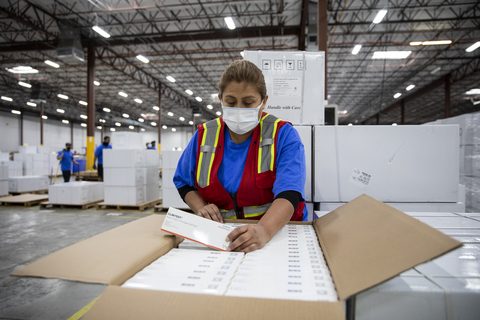 Warehouse employees work to get Siemens Healthineers CLINITEST® Rapid COVID-19 Antigen Self-Test packages assembled and ready for shipment. (Photo: Scott Dalton/AP Images for Siemens Healthineers)