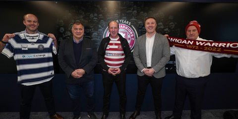 OpenExchange and The Wigan Warriors celebrate the signing of their new partnership. From left to right: Ben Burnside - Managing Director, Head of Investor Relations at OpenExchange, Shaun Wane - Leadership and Management Director at Wigan Warriors, Mark Loehr - Chief Executive Officer at OpenExchange, Kris Radlinski - Executive Director at Wigan Warriors, Travis Macilwain - Director of International Accounting and Finance at OpenExchange. (Photo: Business Wire)