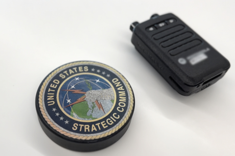 IoT/AI's wearable alerting device prototype is shown side-by-side with the handheld device that is currently used by the Air Force. (Sean Green/STRIKEWERX)