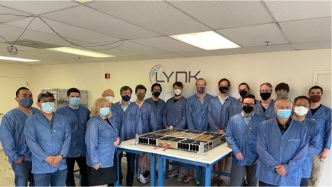 The team that designed and built Lynk’s 5th satellite. This unique “pizza box” satellite design is optimized for satellite-direct-to-phone, mass production, and future scalability. www.lynk.world (Photo: Business Wire)