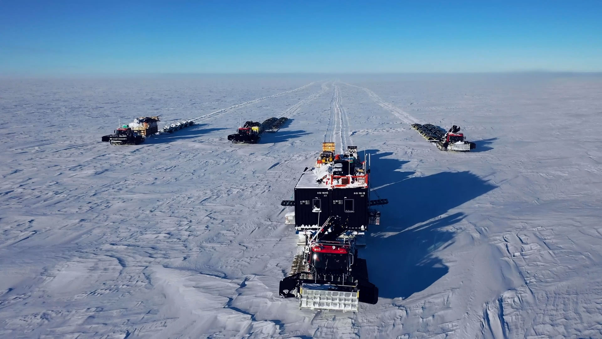 Deep Field traverse team of four Pistenbully tractors. Each tows Lehman Sledge units containing living quarters, equipment, supplies and fuel required for the weeks or months they will be traveling.