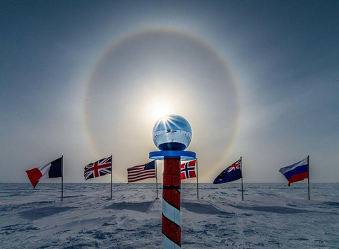 Sun dog at the Ceremonial South Pole, surrounded by the flags of the member countries to the Antarctic Treaty. (Photo: Business Wire)