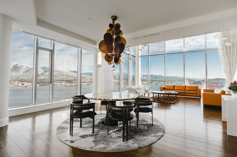 Natural light shines through the modern dining room and living room of the penthouse, with custom furnishings by House of Bohn. (Photo: Business Wire)