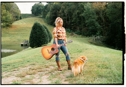 Miranda Lambert poses with her dog and a guitar. (Photo Credit: Acacia Evans)