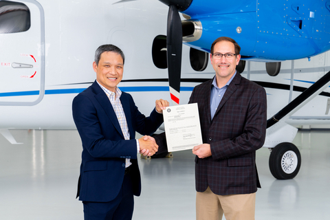 The FAA’s Paul (Vu) Nguyen, acting manager of the Wichita ACO Branch (left) presents type certification of the Cessna SkyCourier to Chris Hearne, Textron Aviation’s senior vice president of Engineering. (Photo: Business Wire)