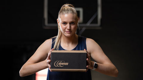 Cate Reese, forward for the University of Arizona women’s basketball team and a three-time All-Pac-12 selection, poses with a Newegg shipping box. Reese is promoting Newegg during this month’s women’s basketball tournament as part of an NIL deal. (Photo: Business Wire)