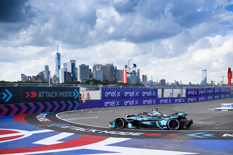 A view of the New York City skyline lies in the background as racers speed around the Attack Mode turn. (Photo: Business Wire)