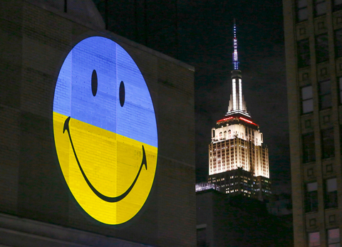 To celebrate International Day of Happiness, The Smiley Company unveiled a series of large-scale projections around the world, including New York City and Los Angeles, featuring the iconic smiley logo in the colors of the Ukrainian flag, Sunday, March 20, 2022 in New York. The projections are in support of the United Nations International Day of Happiness 
