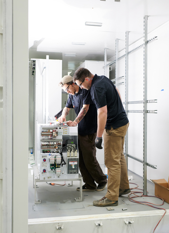 Lucas Comstock [right] and Nick Meerburg work on an energy storage unit in NRI’s Waterbury, Vermont workshop. KORE Power has acquired NRI and launched KORE Solutions, the first U.S.-based vertically integrated energy storage solution provider. (Photo: Business Wire)