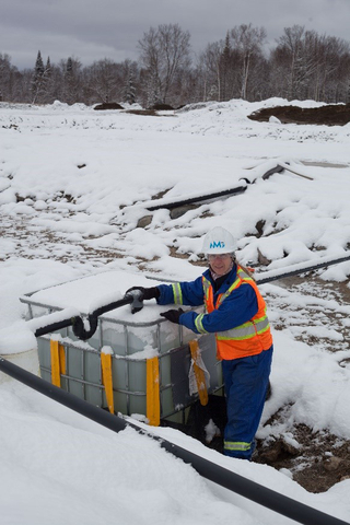 Martine Paradis, VP Environment, Engineering and Matawinie Mine monitors water quality at the experimental test cells. (Photo: Business Wire)