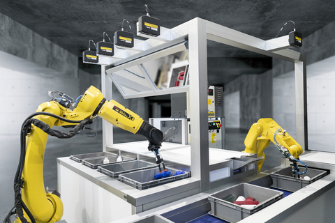 A FANUC M-10iD/12 robot guided by four 3DV/400 vision sensors mounted over the workcell picks various combinations of products from four separate totes to demonstrate vision-guided piece picking. (Photo: Business Wire)
