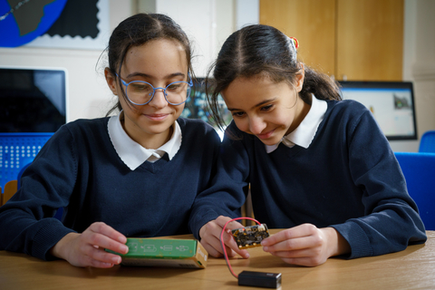 Children developing important digital skills together with a micro:bit device. (Photo: Business Wire)